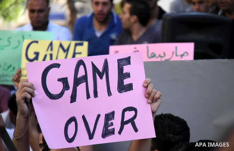 Palestinian protesters wear Guy Fawkes masks as they hold an effigy of Palestinian Prime Minister Salam Fayyad during a protest against the high cost of living, in the West Bank city of Hebron September 4, 2012. The Arab...