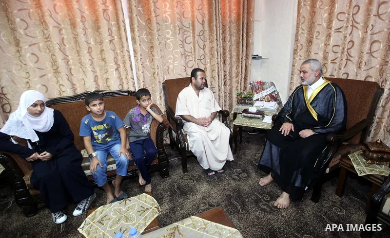 Ismail Haniya, the head of the Hamas government in the Gaza Strip, receives the family of the martyr Ihab Abu Nada in Gaza City on September 5, 2012. The death of a young Gaza man who set himself on fire because he could...