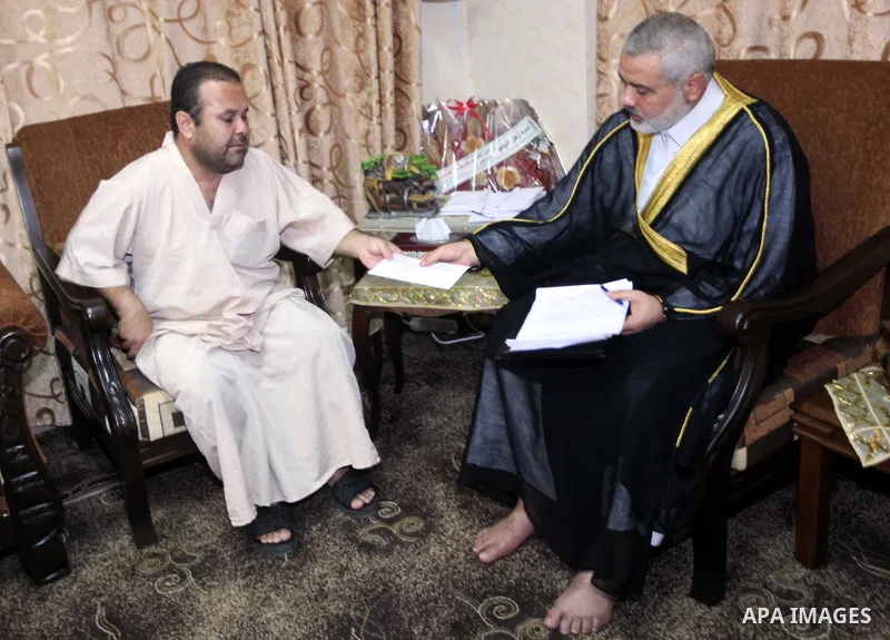 Ismail Haniya, the head of the Hamas government in the Gaza Strip, receives the family of the martyr Ihab Abu Nada in Gaza City on September 5, 2012. The death of a young Gaza man who set himself on fire because he could...