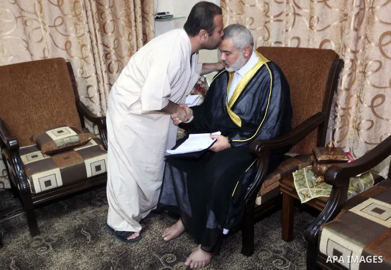 Ismail Haniya, the head of the Hamas government in the Gaza Strip, receives the family of the martyr Ihab Abu Nada in Gaza City on September 5, 2012. The death of a young Gaza man who set himself on fire because he could...