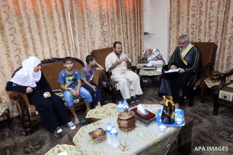 Ismail Haniya, the head of the Hamas government in the Gaza Strip, receives the family of the martyr Ihab Abu Nada in Gaza City on September 5, 2012. The death of a young Gaza man who set himself on fire because he could...