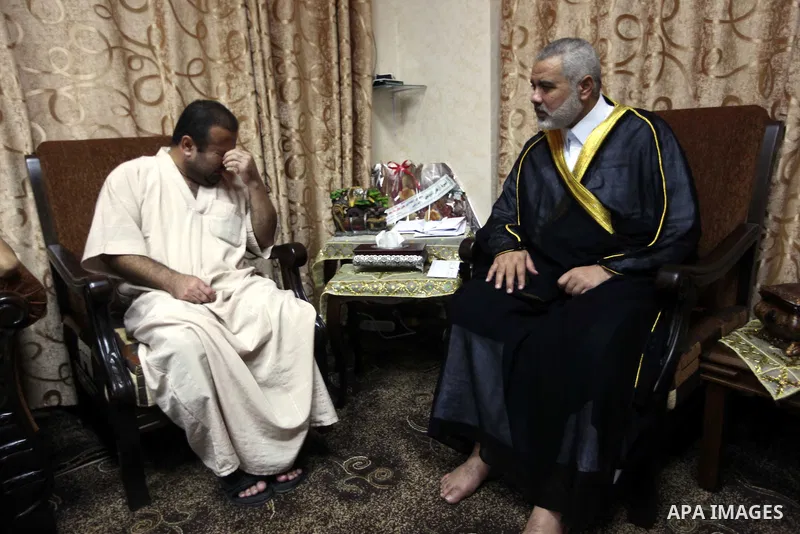 Ismail Haniya, the head of the Hamas government in the Gaza Strip, receives the family of the martyr Ihab Abu Nada in Gaza City on September 5, 2012. The death of a young Gaza man who set himself on fire because he could...