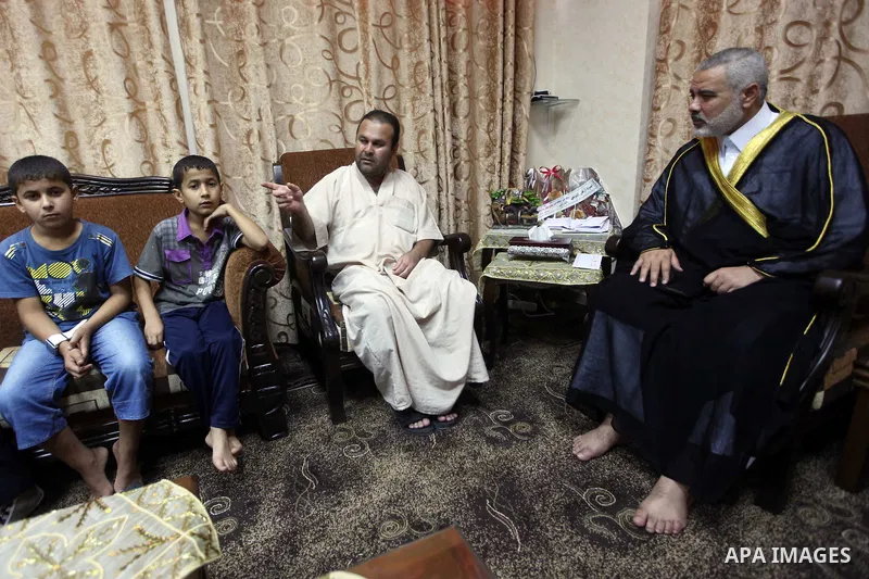 Ismail Haniya, the head of the Hamas government in the Gaza Strip, receives the family of the martyr Ihab Abu Nada in Gaza City on September 5, 2012. The death of a young Gaza man who set himself on fire because he could...