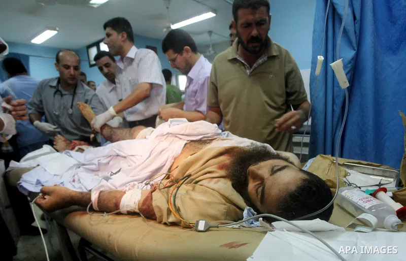 A wounded Palestinian man receives treatment at the al-Aqsa hospital in Deir al-Balah, Gaza strip center, following an Israeli airstrike on September 5, 2012. Photo by Ashraf Amra