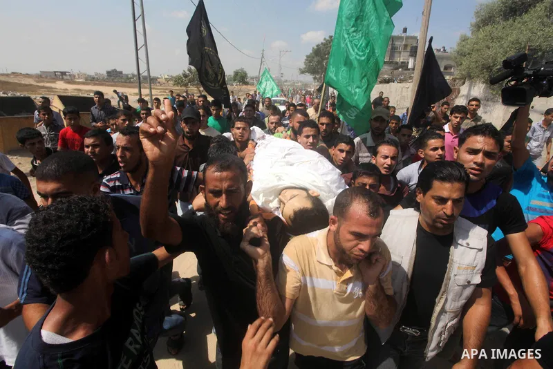 Palestinian mourners carry the body of Tareq al-Kafarna mourn during his funeral in Beit Hanun in the northern Gaza Strip on September 6, 2012. Three Palestinians were killed by Israeli fire in the northern Gaza Strip, r...