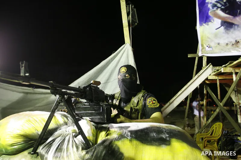 Militants from the Al-Quds Brigades march on patrol in a street in Rafah, southern Gaza strip, on September 6, 2012. An Israeli air strike on the Hamas-governed Gaza Strip killed three gunmen, one of them Al-Geram, as th...