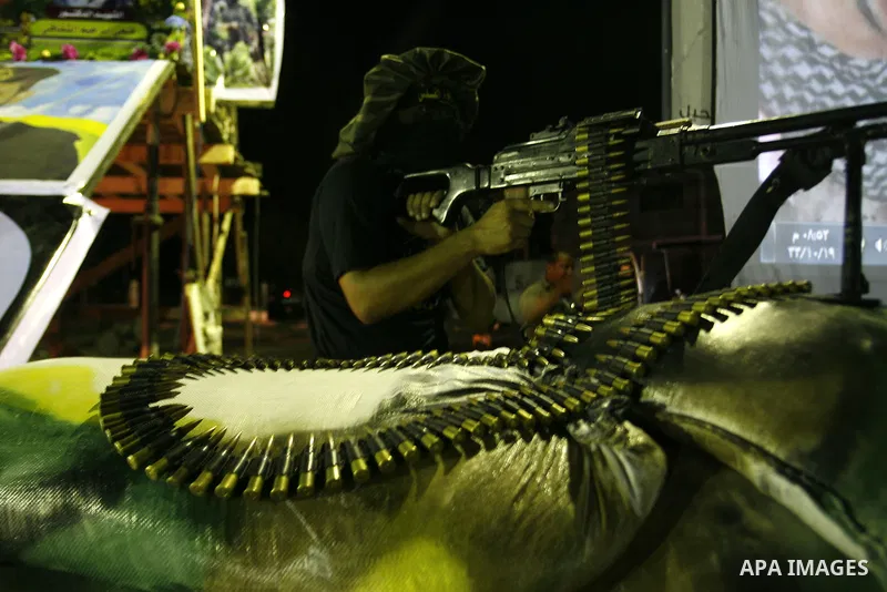 Militants from the Al-Quds Brigades march on patrol in a street in Rafah, southern Gaza strip, on September 6, 2012. An Israeli air strike on the Hamas-governed Gaza Strip killed three gunmen, one of them Al-Geram, as th...