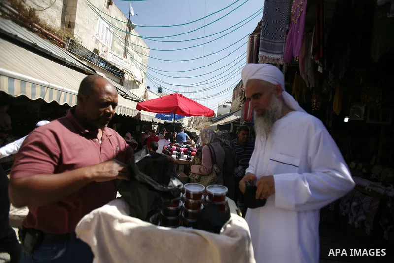 Palestinians walk in front of the Dome of Rock mosque during Friday prayers, in the Al Aqsa Mosque compound, in Jerusalem's old city on Sep. 07, 2012. Photo by Mahfouz Abu Turk
