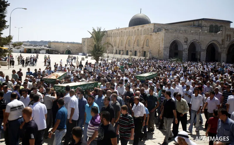 Palestinians walk in front of the Dome of Rock mosque during Friday prayers, in the Al Aqsa Mosque compound, in Jerusalem's old city on Sep. 07, 2012. Photo by Mahfouz Abu Turk