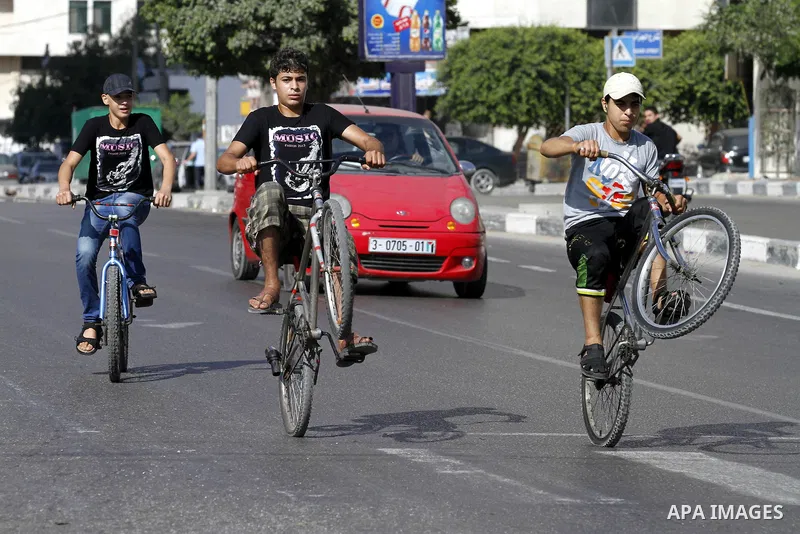 Palestinian youth ride a bicycle on a street in Gaza City, on Sep. 07, 2012. Photo by Majdi Fathi