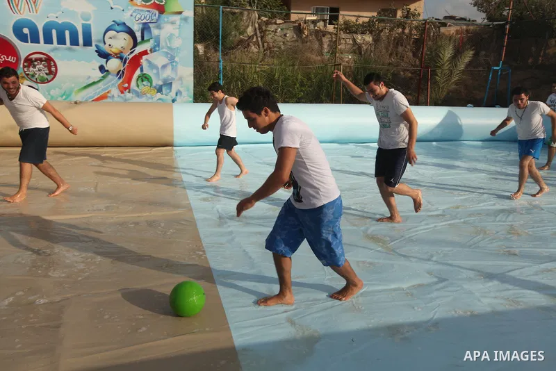 Palestinian youths enjoy play foot ball in an amusement Si Lamy park southern Gaza Strip on Sep. 07, 2012. Photo by Majdi Fathi