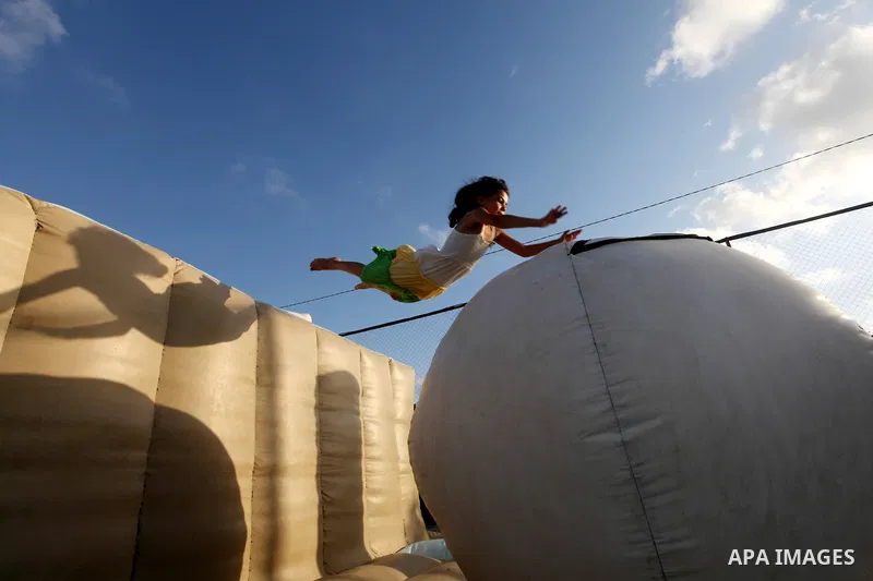 Palestinian children enjoy jump in an amusement Si Lamy park southern Gaza Strip on Sep. 07, 2012. Photo by Majdi Fathi