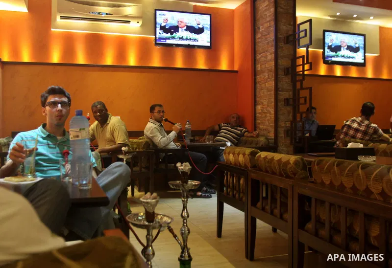 Palestinians watch TV as President Mahmoud Abbas (Abu Mazen), delivers speech to discusses the economic situation in the West Bank and Gaza strip, In a cafe in the West Bank city of Nablus on Sep. 08, 2012. Photo by Neda...