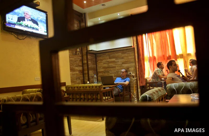 Palestinians watch TV as President Mahmoud Abbas (Abu Mazen), delivers speech to discusses the economic situation in the West Bank and Gaza strip, In a cafe in the West Bank city of Nablus on Sep. 08, 2012. Photo by Neda...