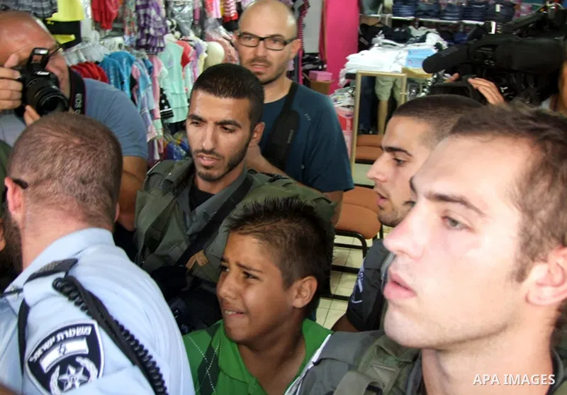 A Palestinian boy is arrested by Israeli security forces during a demonstration in solidarity with Palestinian prisoners in Israeli jails outside Damascus Gate in the old city of Jerusalem on September 8, 2012. Photo by...