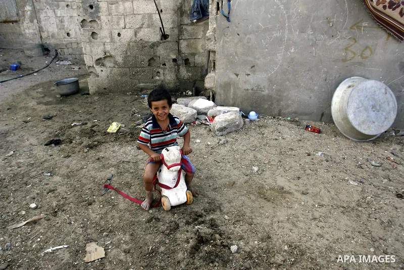 A Palestinian child plays in front of his house in Rafah refugee camp in the southern of Gaza Strip, on September 08. 2012. Photo by Eyad Al Baba