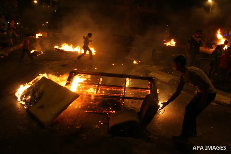 A Palestinian youth burns tyres during a protest against the high cost of living at Al-Amari refugee camp in the West Bank city of Ramallah on September 8, 2012. Dozens of Palestinians burned tyres and blocked the road i...