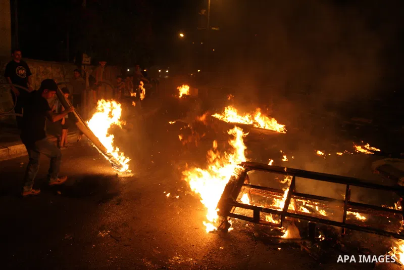 Palestinians youth burn tyres during a protest against the high cost of living at Al-Amari refugee camp in the West Bank city of Ramallah on September 8, 2012. Dozens of Palestinians burned tyres and blocked the road int...