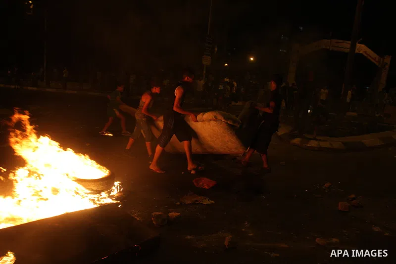 Palestinians youth burn tyres during a protest against the high cost of living at Al-Amari refugee camp in the West Bank city of Ramallah on September 8, 2012. Dozens of Palestinians burned tyres and blocked the road int...