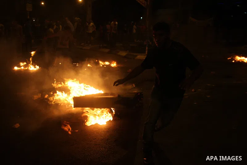 Palestinians youth burn tyres during a protest against the high cost of living at Al-Amari refugee camp in the West Bank city of Ramallah on September 8, 2012. Dozens of Palestinians burned tyres and blocked the road int...