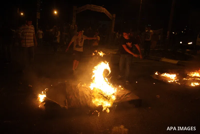 Palestinians youth burn tyres during a protest against the high cost of living at Al-Amari refugee camp in the West Bank city of Ramallah on September 8, 2012. Dozens of Palestinians burned tyres and blocked the road int...
