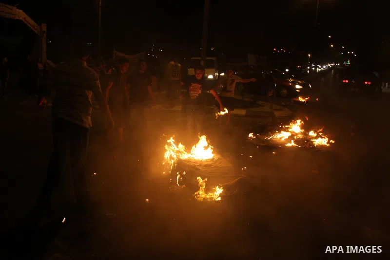 Palestinians youth burn tyres during a protest against the high cost of living at Al-Amari refugee camp in the West Bank city of Ramallah on September 8, 2012. Dozens of Palestinians burned tyres and blocked the road int...