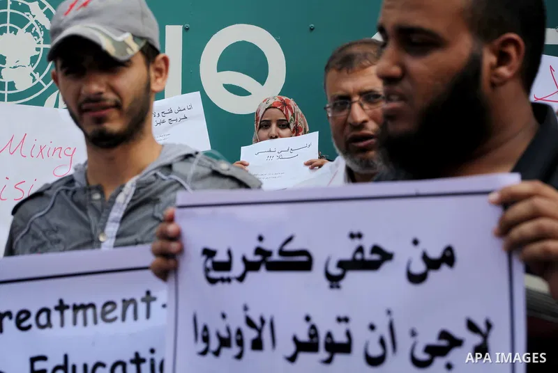 Palestinians take part in a protest against unemployment and the economic situation in the Gaza Strip, in front of the UNRWA headquarters in Gaza city on Sep. 09, 2012. Photo by Ashraf Amra