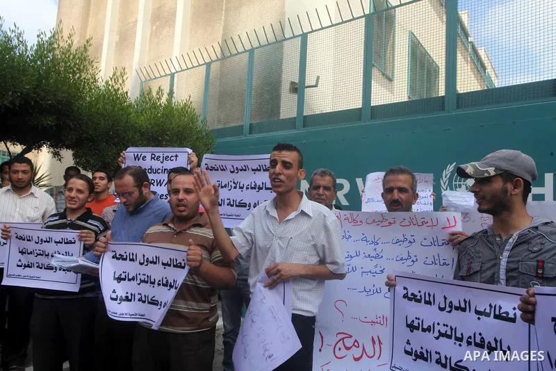 Palestinians take part in a protest against unemployment and the economic situation in the Gaza Strip, in front of the UNRWA headquarters in Gaza city on Sep. 09, 2012. Photo by Ashraf Amra