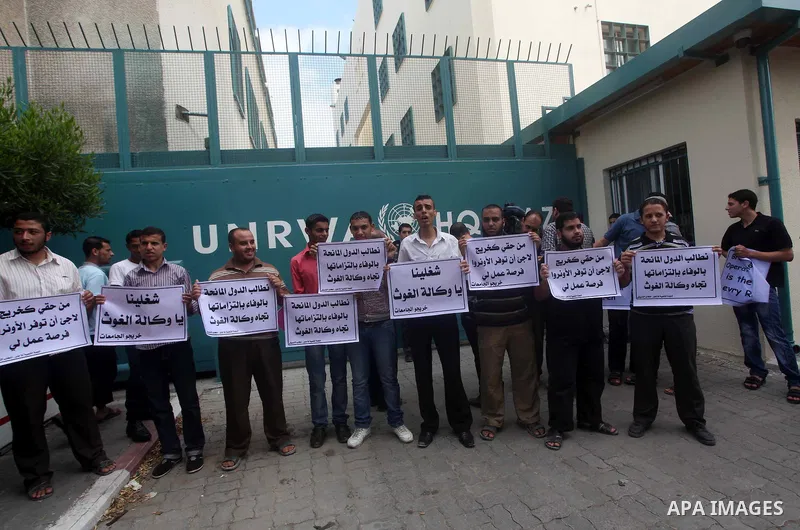 Palestinians take part in a protest against unemployment and the economic situation in the Gaza Strip, in front of the UNRWA headquarters in Gaza city on Sep. 09, 2012. Photo by Ashraf Amra