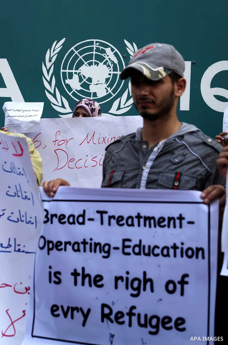 Palestinians take part in a protest against unemployment and the economic situation in the Gaza Strip, in front of the UNRWA headquarters in Gaza city on Sep. 09, 2012. Photo by Ashraf Amra