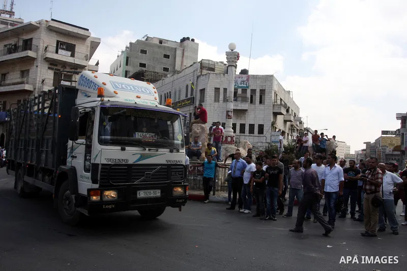Palestinian truck drivers block a road during a protest against the high cost of living in the West Bank city of Ramallah, Sunday, Sep. 09, 2012. Photo by Issam Rimawi