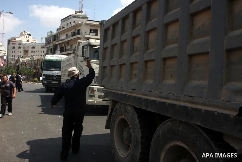 Palestinian truck drivers block a road during a protest against the high cost of living in the West Bank city of Ramallah, Sunday, Sep. 09, 2012. Photo by Issam Rimawi