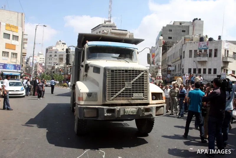 Palestinian truck drivers block a road during a protest against the high cost of living in the West Bank city of Ramallah, Sunday, Sep. 09, 2012. Photo by Issam Rimawi