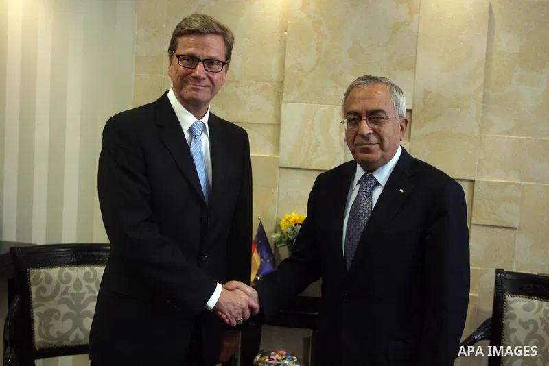 Palestinian Prime Minister Salam Fayyad (R) shakes hands with Germany's Foreign Minister Guido Westerwelle during their meeting in the West Bank city of Ramallah September 9, 2012. Westerwelle urged Iran on Sunday to bri...