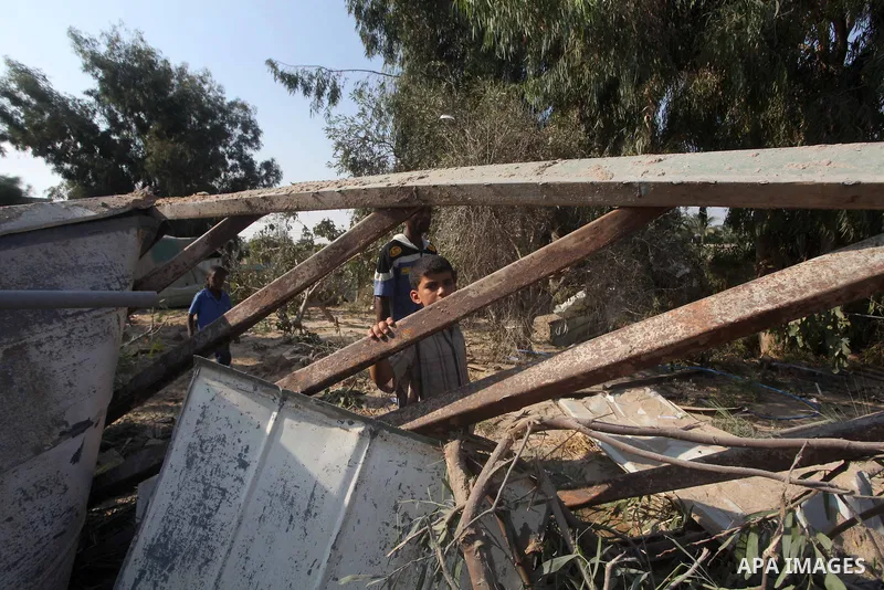 Palestinians inspect the damage to a building after an Israeli air strike in Nuseirat refugee camp in the central Gaza Strip September 10, 2012. An Israeli army statement said the Israeli air force targeted four sites in...