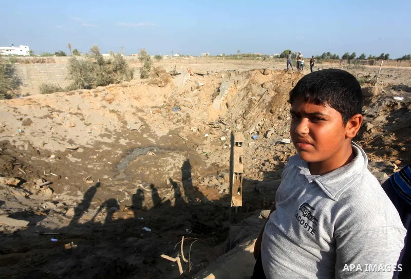 Palestinians inspect the damage to a building after an Israeli air strike in Nuseirat refugee camp in the central Gaza Strip September 10, 2012. An Israeli army statement said the Israeli air force targeted four sites in...