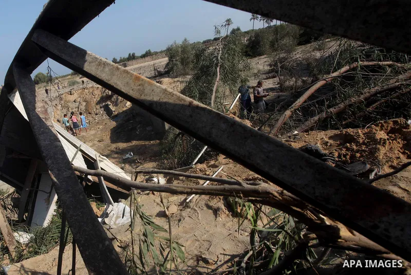Palestinians inspect the damage to a building after an Israeli air strike in Nuseirat refugee camp in the central Gaza Strip September 10, 2012. An Israeli army statement said the Israeli air force targeted four sites in...