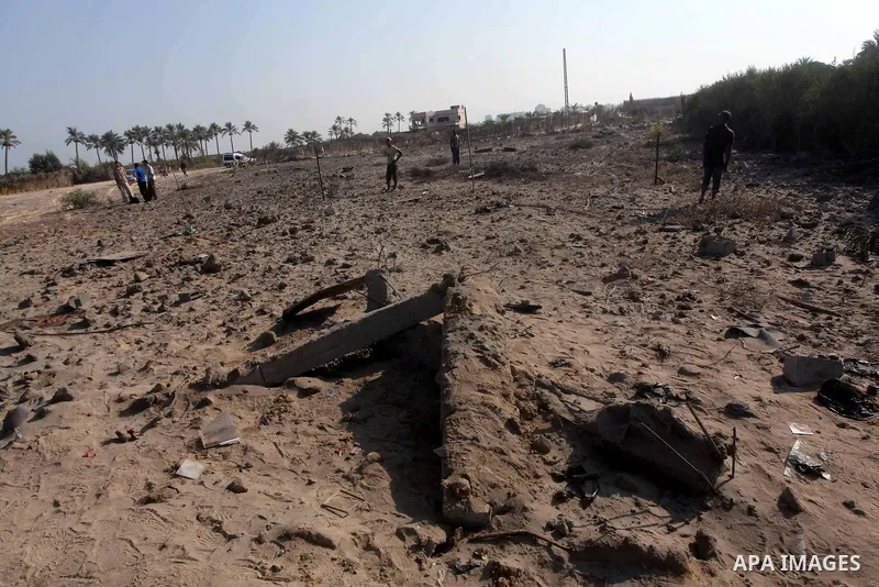 Palestinians inspect the damage to a building after an Israeli air strike in Nuseirat refugee camp in the central Gaza Strip September 10, 2012. An Israeli army statement said the Israeli air force targeted four sites in...
