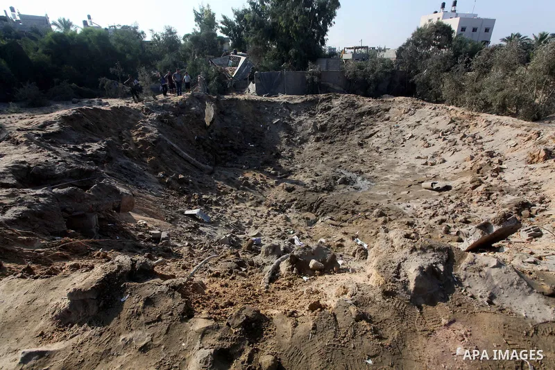Palestinians inspect the damage to a building after an Israeli air strike in Nuseirat refugee camp in the central Gaza Strip September 10, 2012. An Israeli army statement said the Israeli air force targeted four sites in...