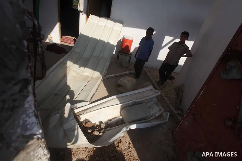 Palestinians inspect the damage to a building after an Israeli air strike in Nuseirat refugee camp in the central Gaza Strip September 10, 2012. An Israeli army statement said the Israeli air force targeted four sites in...