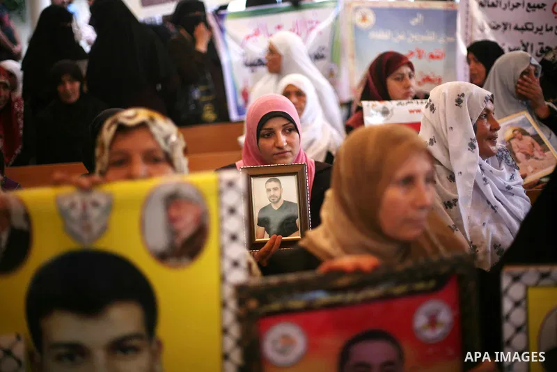 Palestinians hold a placard depicting jailed relatives during a protest in Gaza City calling for the release of Palestinian prisoners from Israeli jails September 10, 2012. Photo by Ashraf Amra