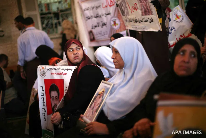 Palestinians hold a placard depicting jailed relatives during a protest in Gaza City calling for the release of Palestinian prisoners from Israeli jails September 10, 2012. Photo by Ashraf Amra