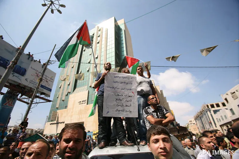 Palestinians chant slogans against Palestinian Prime Minister Salam Fayyad during a protest against the high cost of living in the West Bank city of Hebron, Monday, Sept. 10, 2012. Palestinian demonstrators fed up with h...