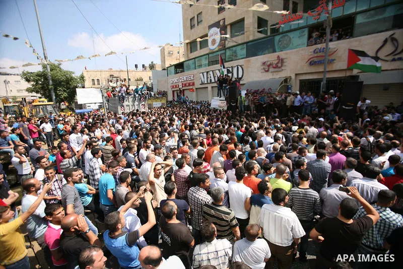 Palestinians chant slogans against Palestinian Prime Minister Salam Fayyad during a protest against the high cost of living in the West Bank city of Hebron, Monday, Sept. 10, 2012. Palestinian demonstrators fed up with h...