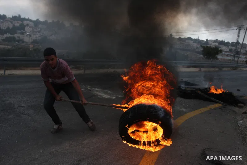 Palestinian youths close streets in Ramallah by burning tires during a protest against the high cost of living on September 10, 2012. Cities across the West Bank ground to a halt as transport unions called a mass general...
