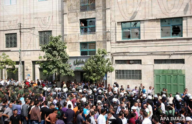 Palestinians shout slogans during a protest against the high cost of living on September 10, 2012 in the West Bank city of Hebron. Cities across the West Bank ground to a halt as transport unions called a mass general st...