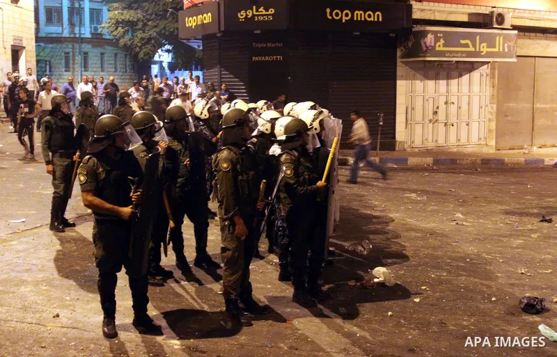 Palestinian security forces disperse crowds during clashes at a demonstration against high living costs and the government in the West Bank city of Nablus September 10, 2012. The Palestinian Authority, which governs Pale...
