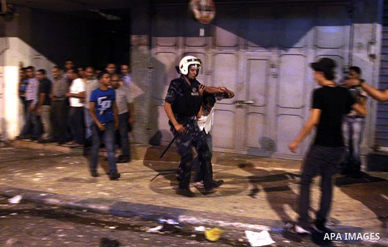 Palestinian security forces disperse crowds during clashes at a demonstration against high living costs and the government in the West Bank city of Nablus September 10, 2012. The Palestinian Authority, which governs Pale...