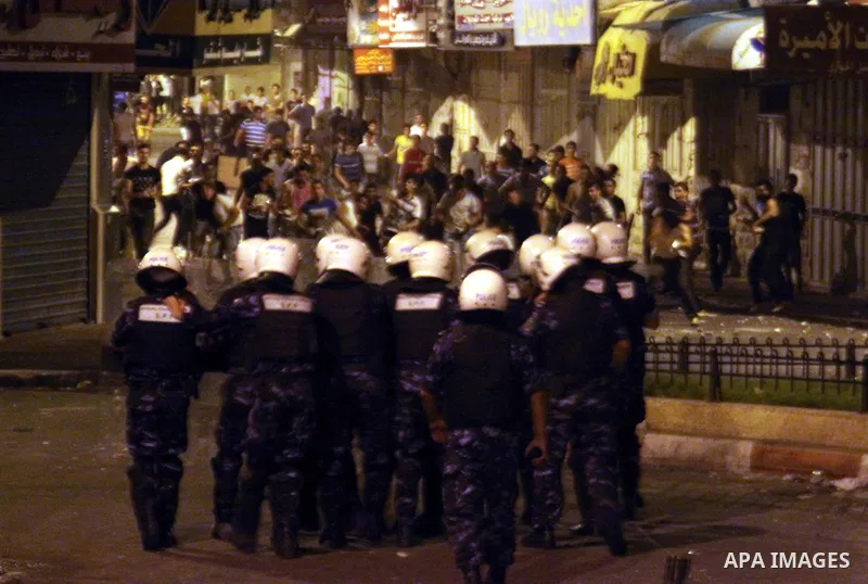 Palestinian security forces disperse crowds during clashes at a demonstration against high living costs and the government in the West Bank city of Nablus September 10, 2012. The Palestinian Authority, which governs Pale...