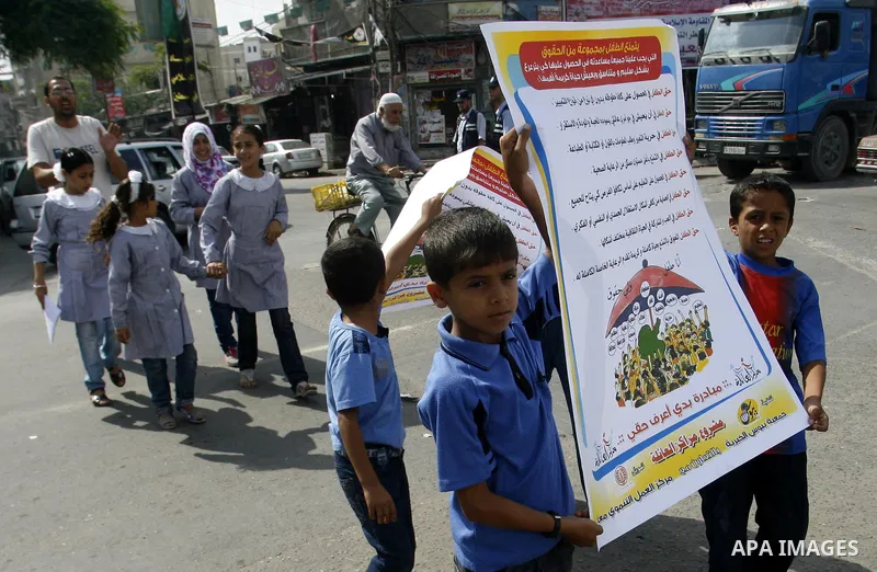 Palestinian students participate in a rally during a campaign to defend their rights in Rafah, in the southern Gaza Strip, Sep. 11, 2012. Photo by Eyad Al Baba